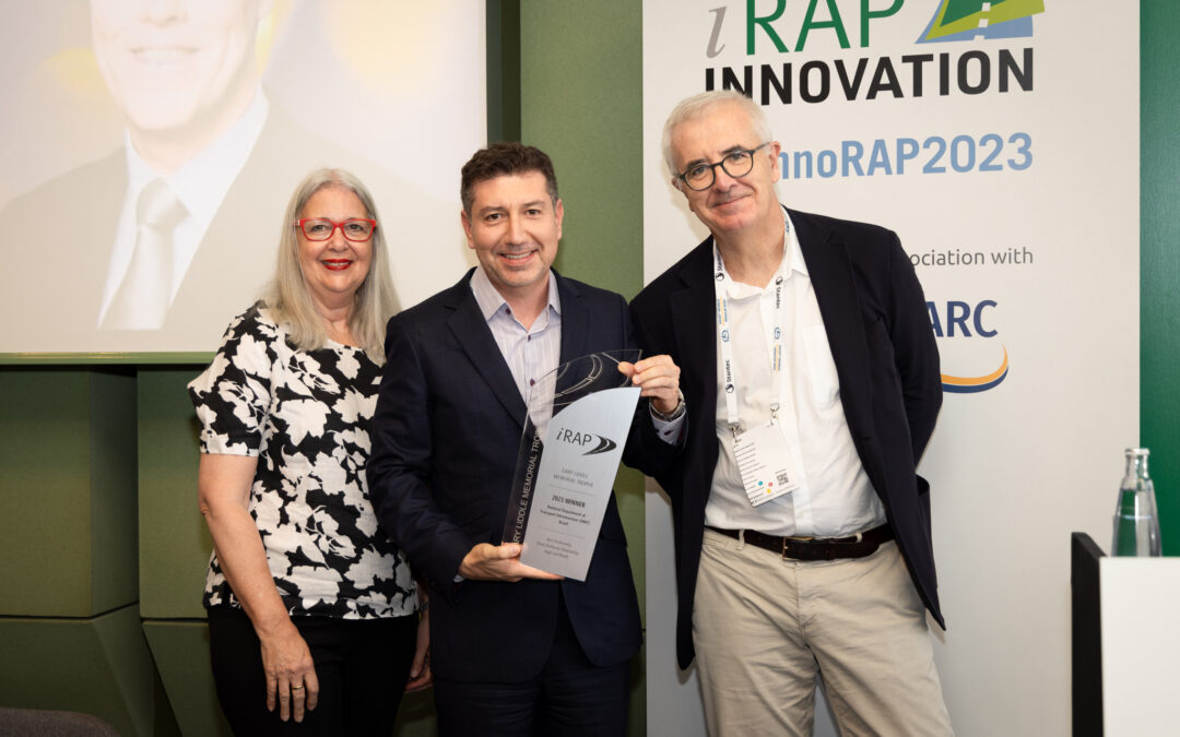 Julio Urzua, iRAP Strategic Projects Director accepts the Winner Trophy on behalf of DNIT -with Mrs Meredith Liddle and Miquel Nadal, iRAP Board Chairman